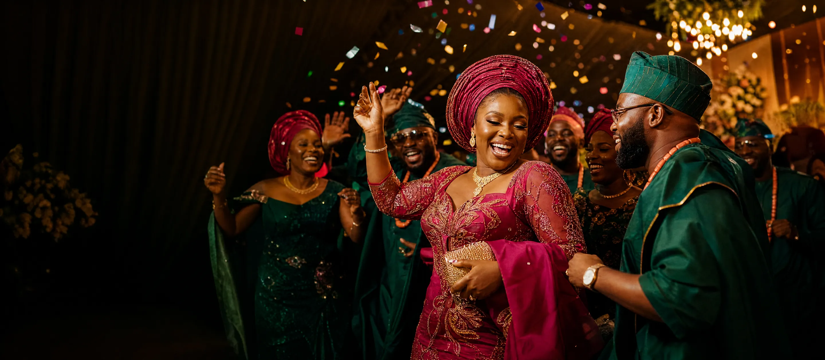 Guests in coordinated Aso Ebi dancing at a Nigerian wedding